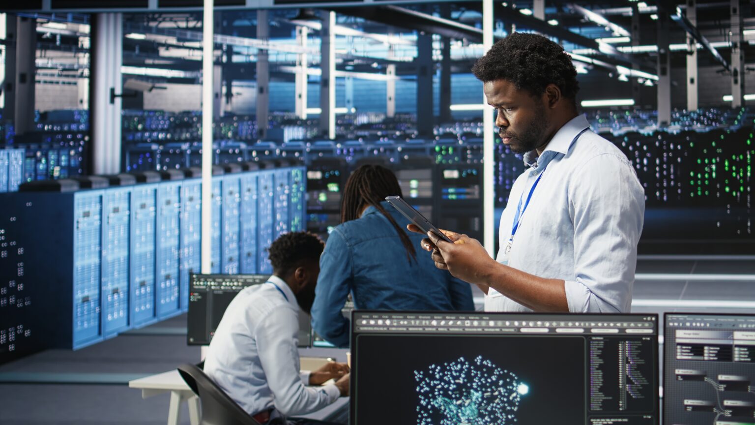 Data center engineer using tablet to interpret AI generated data analytics graphs