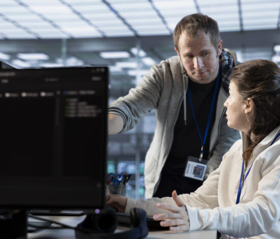 IT engineers in server farm brainstorming ways to repair equipment