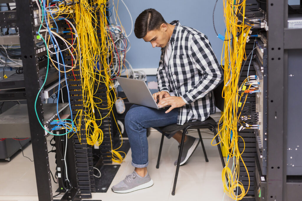 network-engineer-with-laptop-long-shot